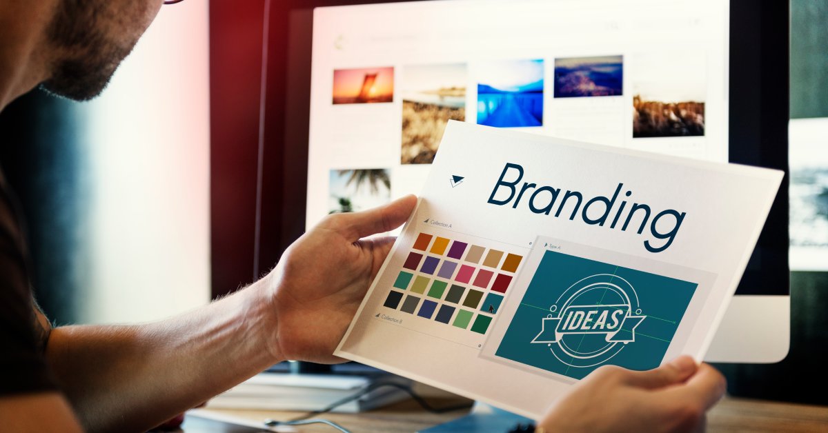 A professional marketer is looking at a paper with the words "Branding" and "Ideas" and has color schemes.